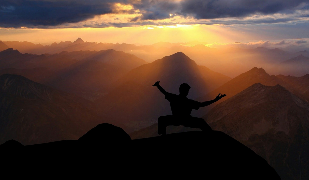 Man clearing mindset on mountain getting ready for exam