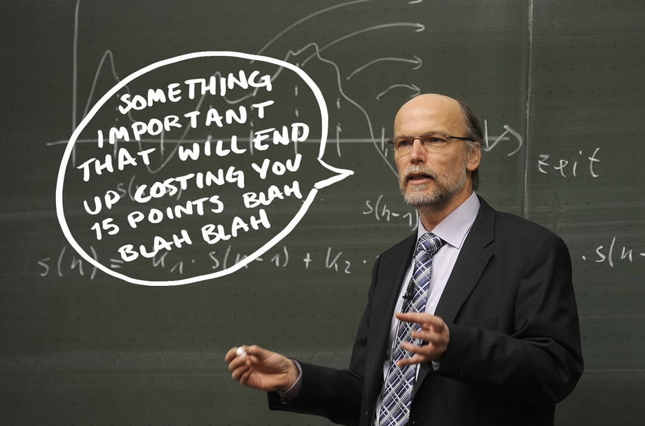 Professor in front of chalkboard saying important things before exam
