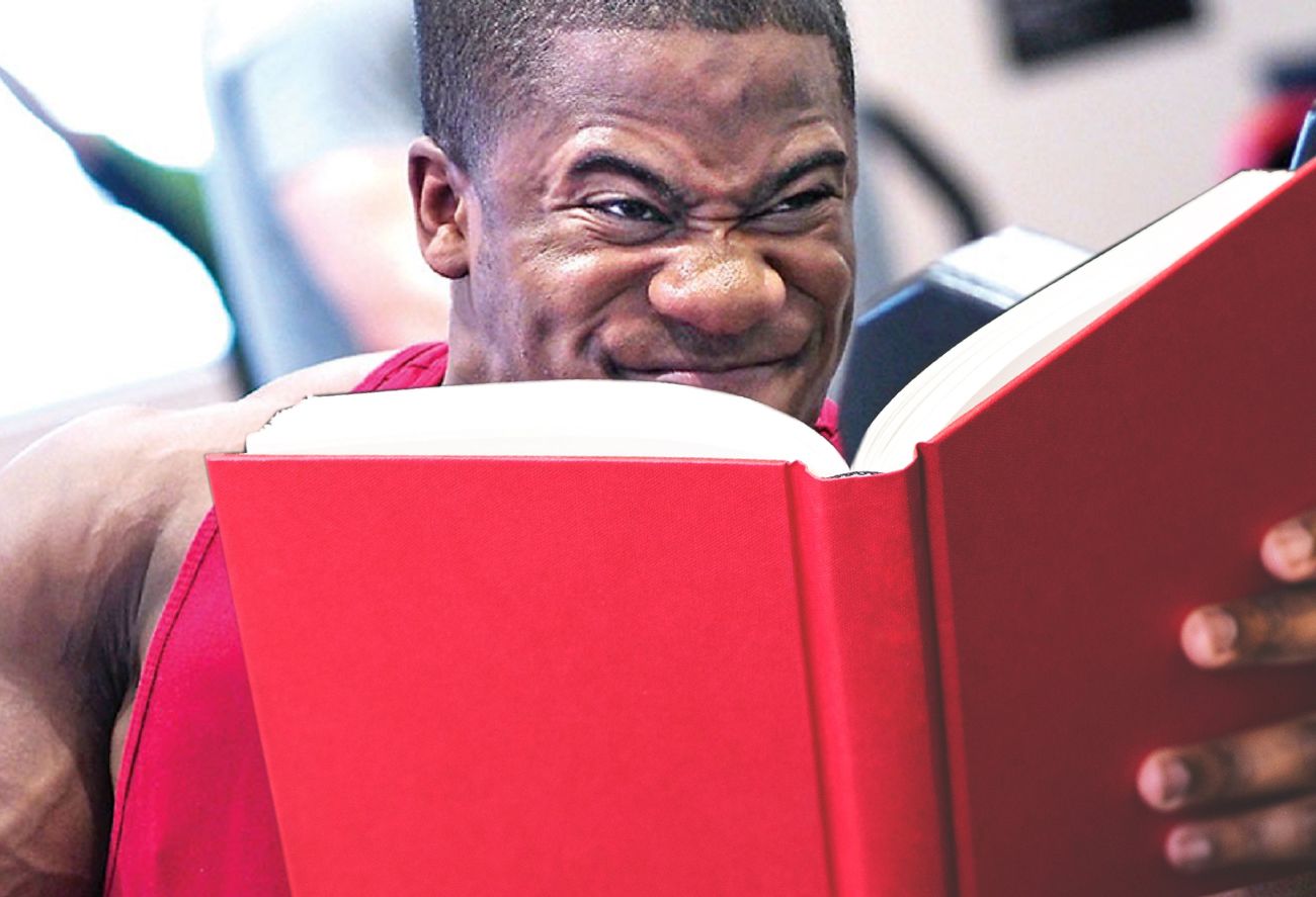 Man reading a book studying in the gym