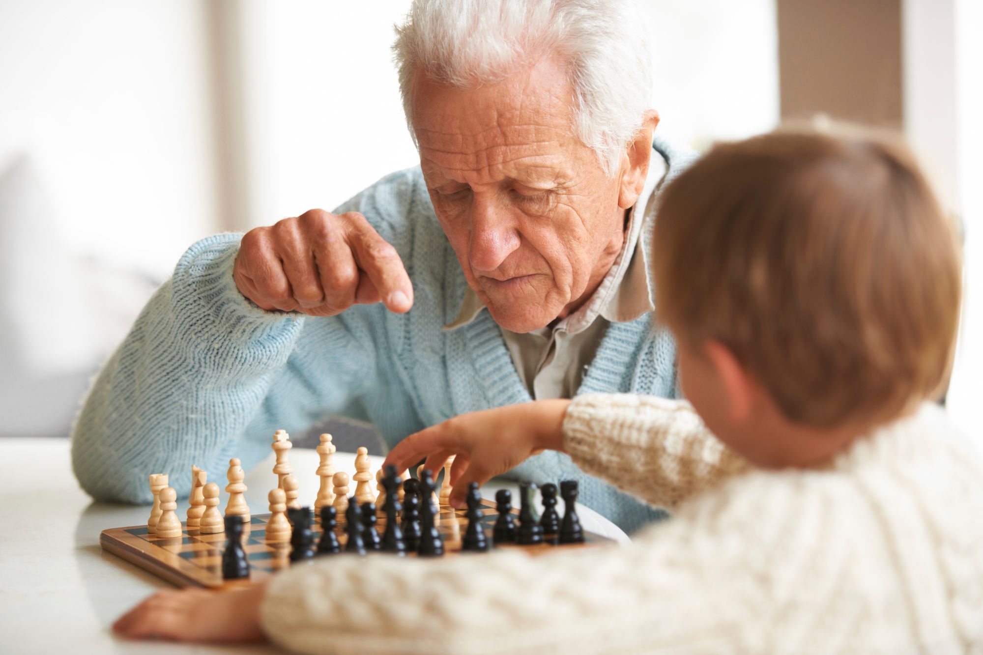 Elderly man playing chess