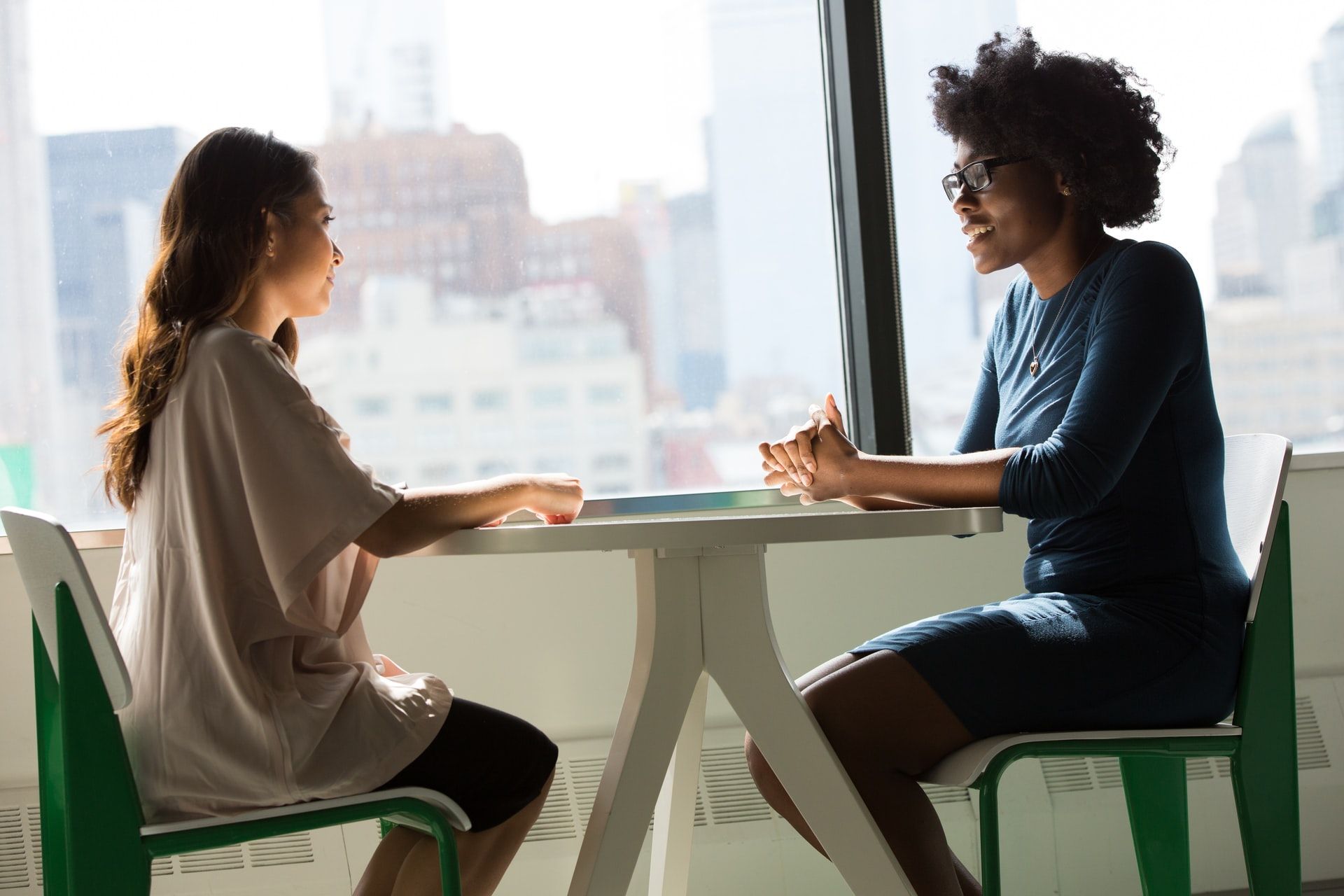 Two women in an interview, good employee traits
