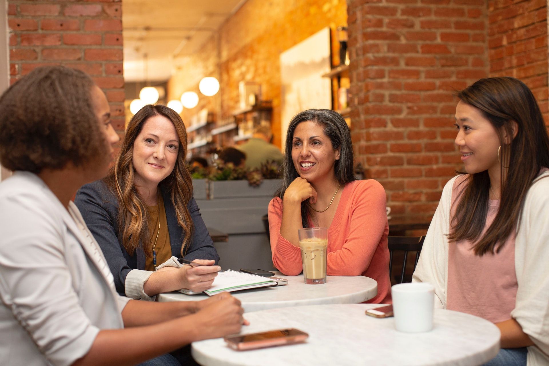 women chatting about career options with coffee