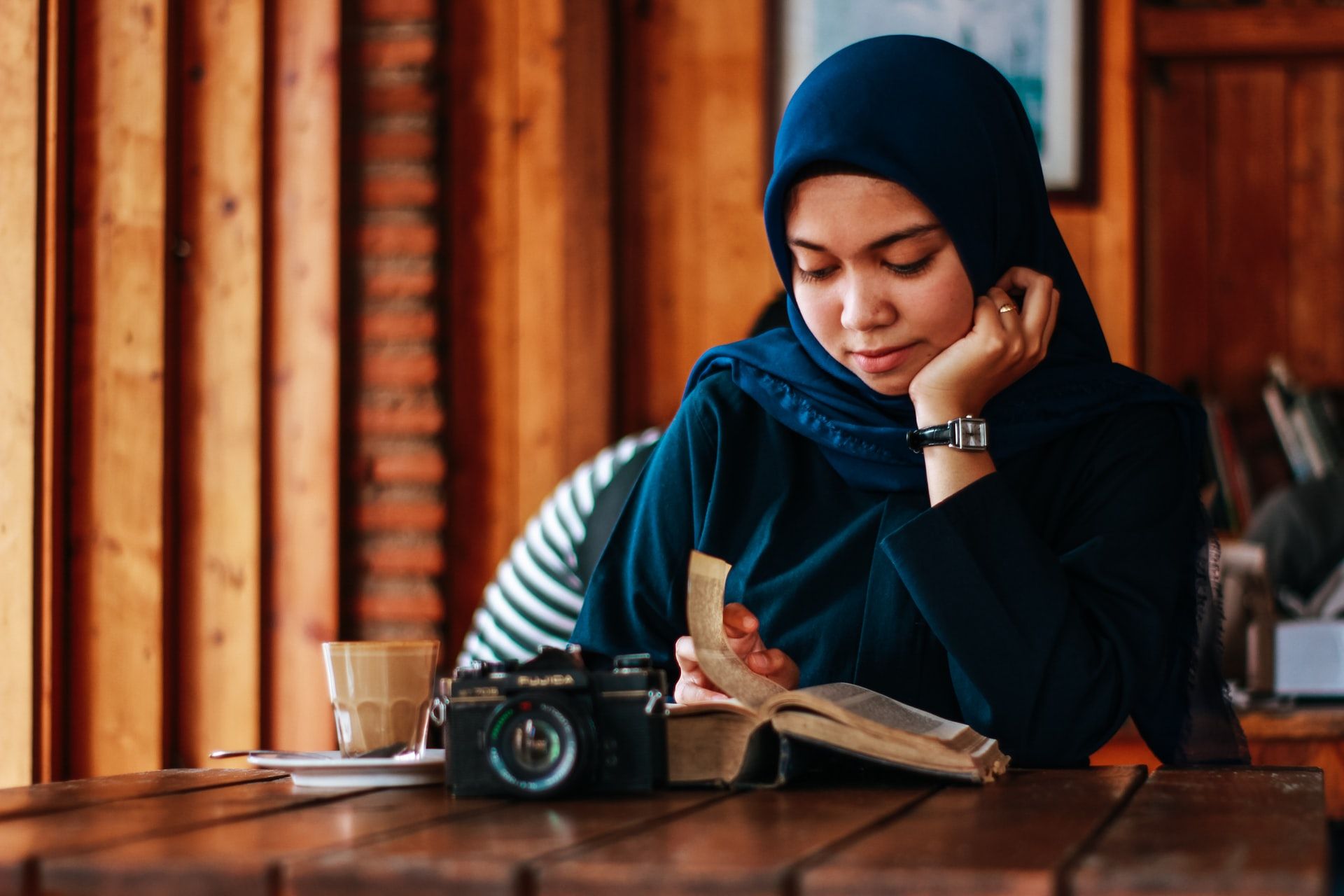 Woman with camera and book, how to read faster