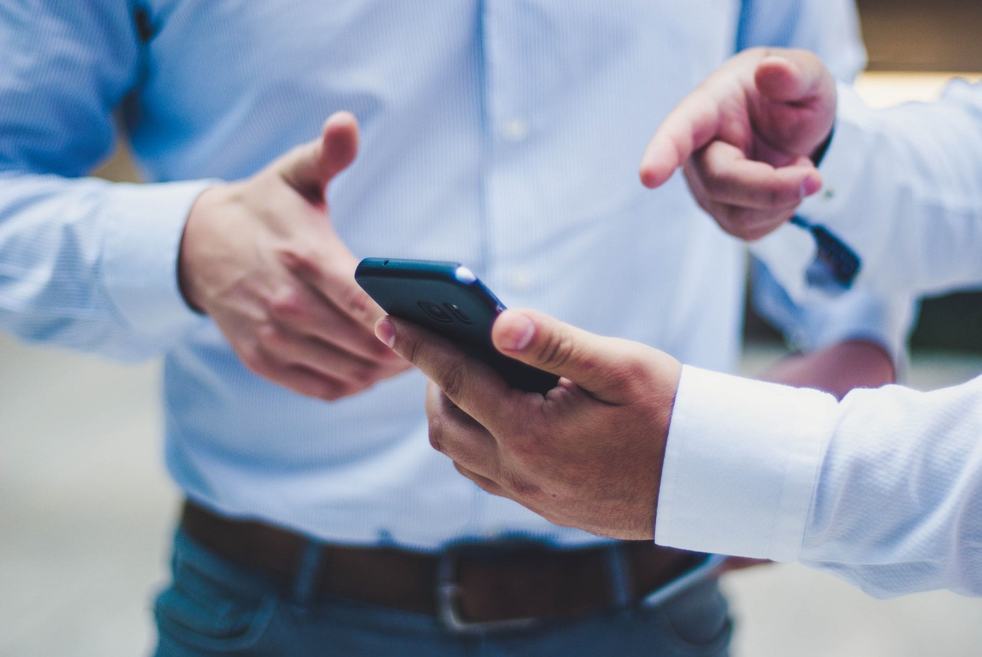 men holding mlearning mobile phone