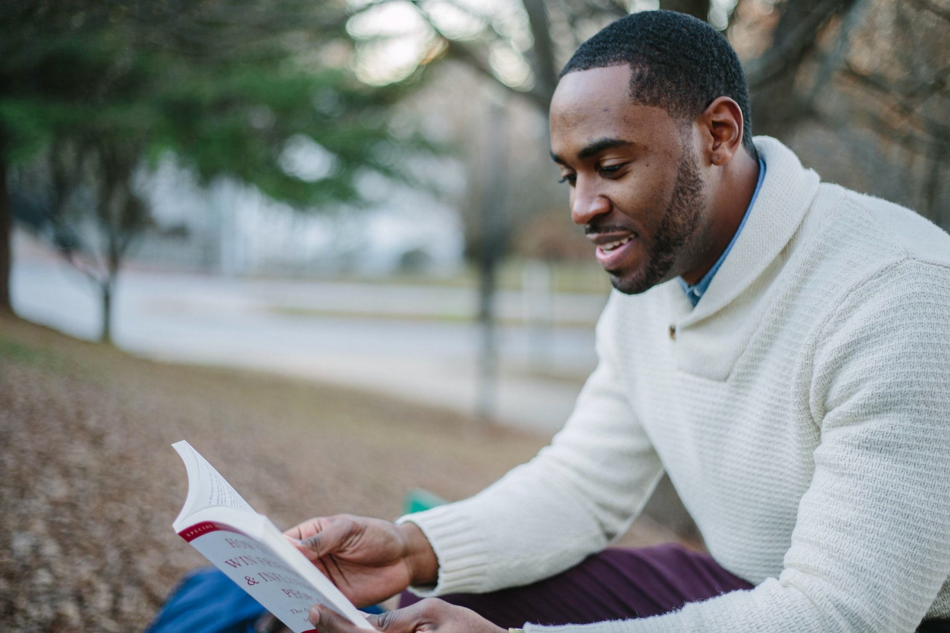 Man reading foreign language in a park