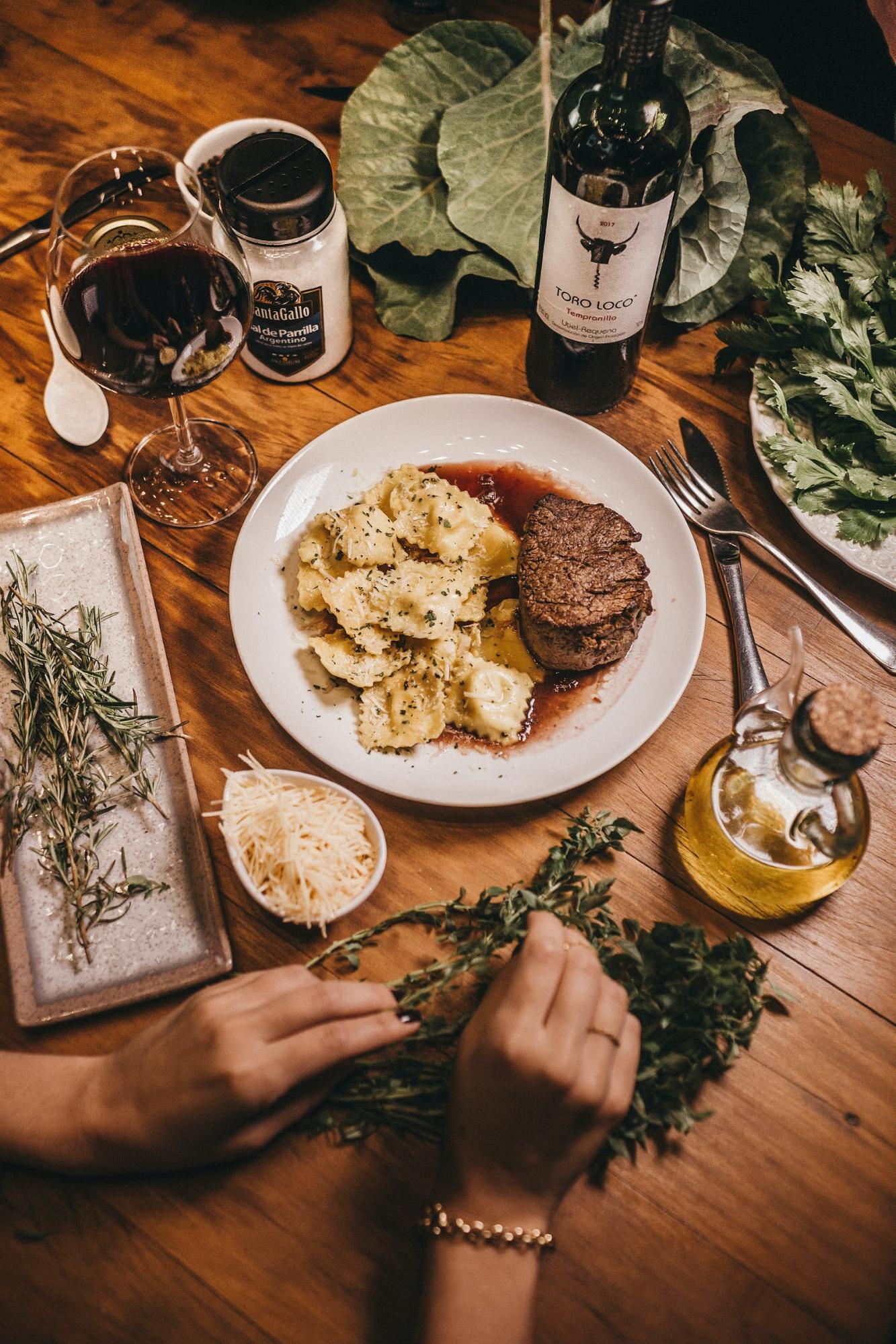 A decadent meal with pasta and red wine