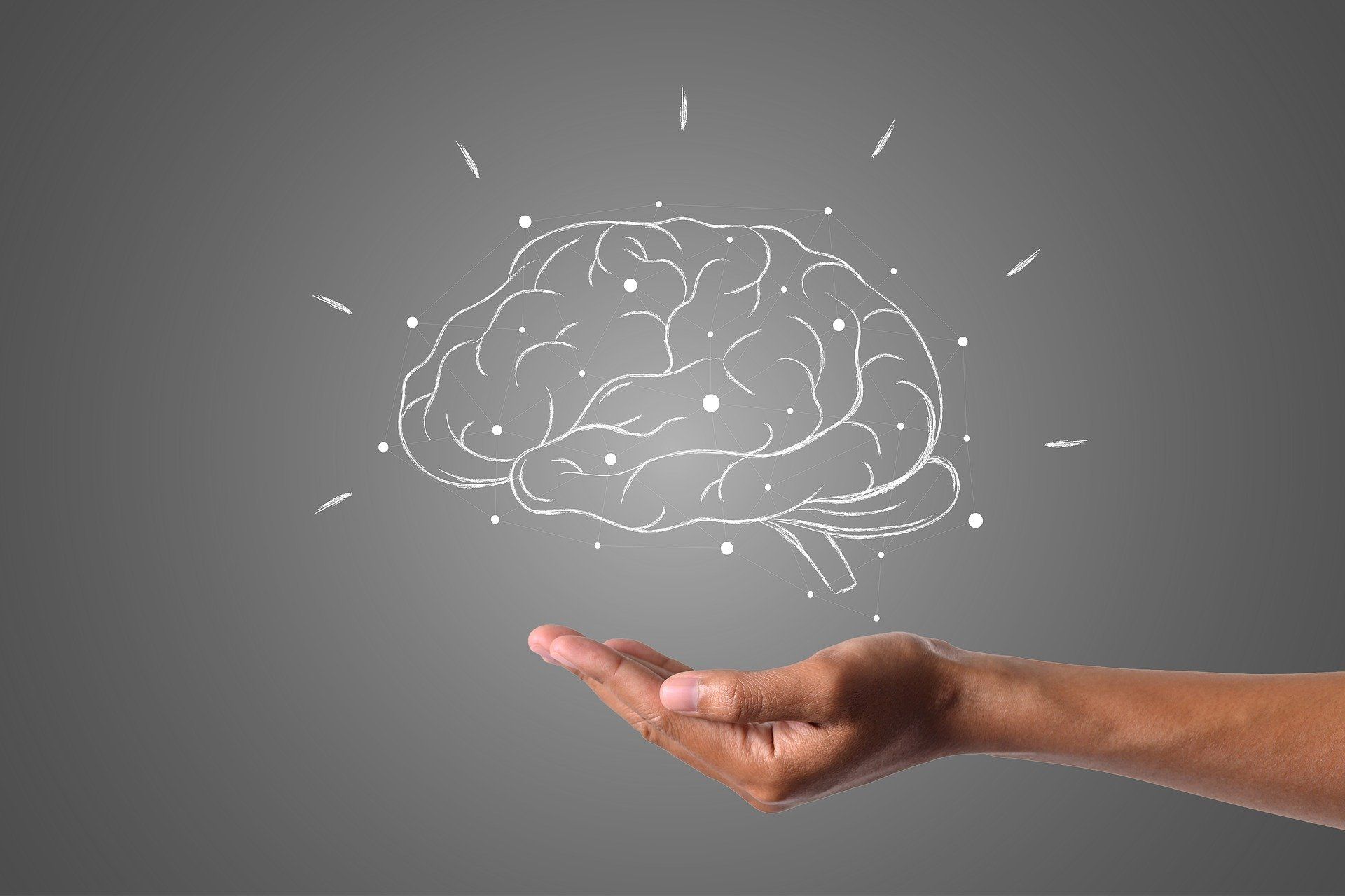 Mano flotando debajo del dibujo de un cerebro;  Cómo permanecer despierto para estudiar
