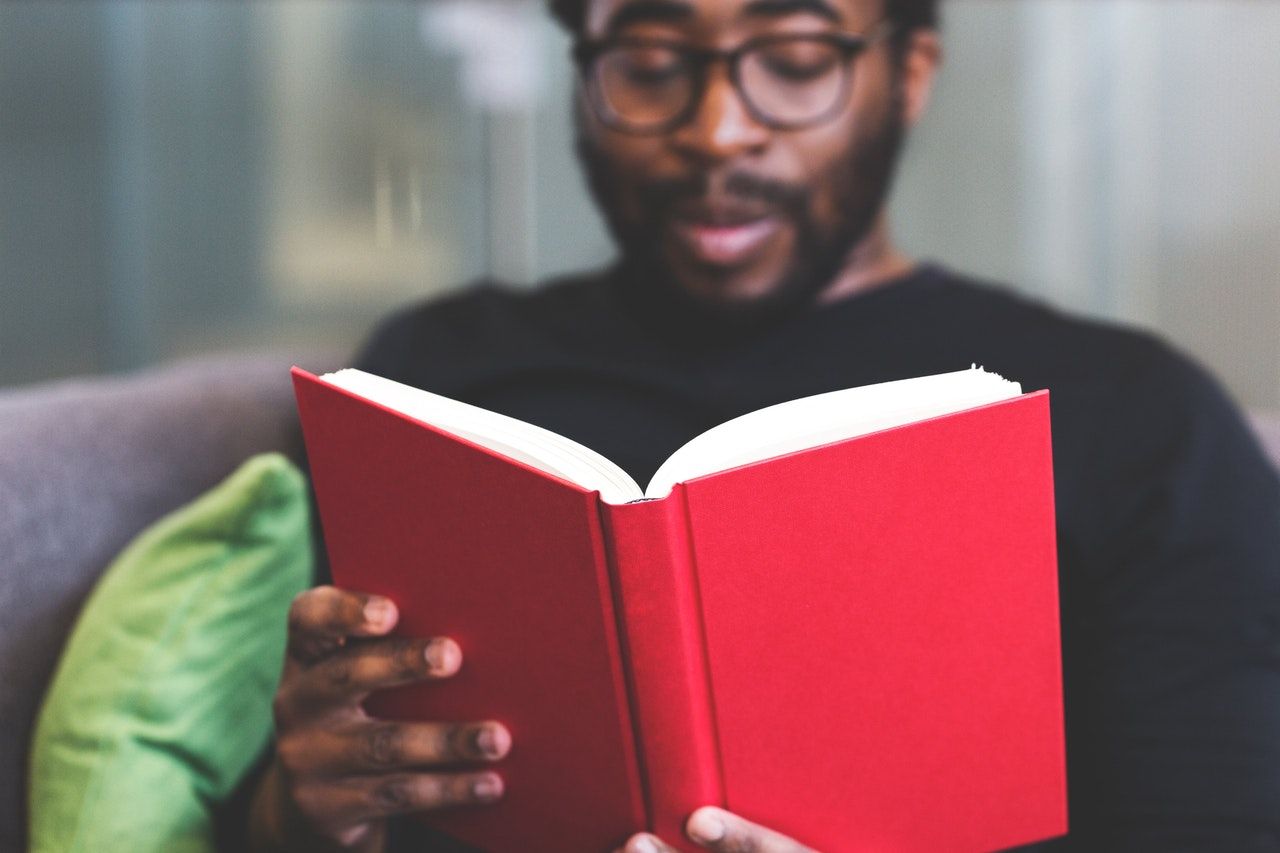 Man reading book study for bar exam