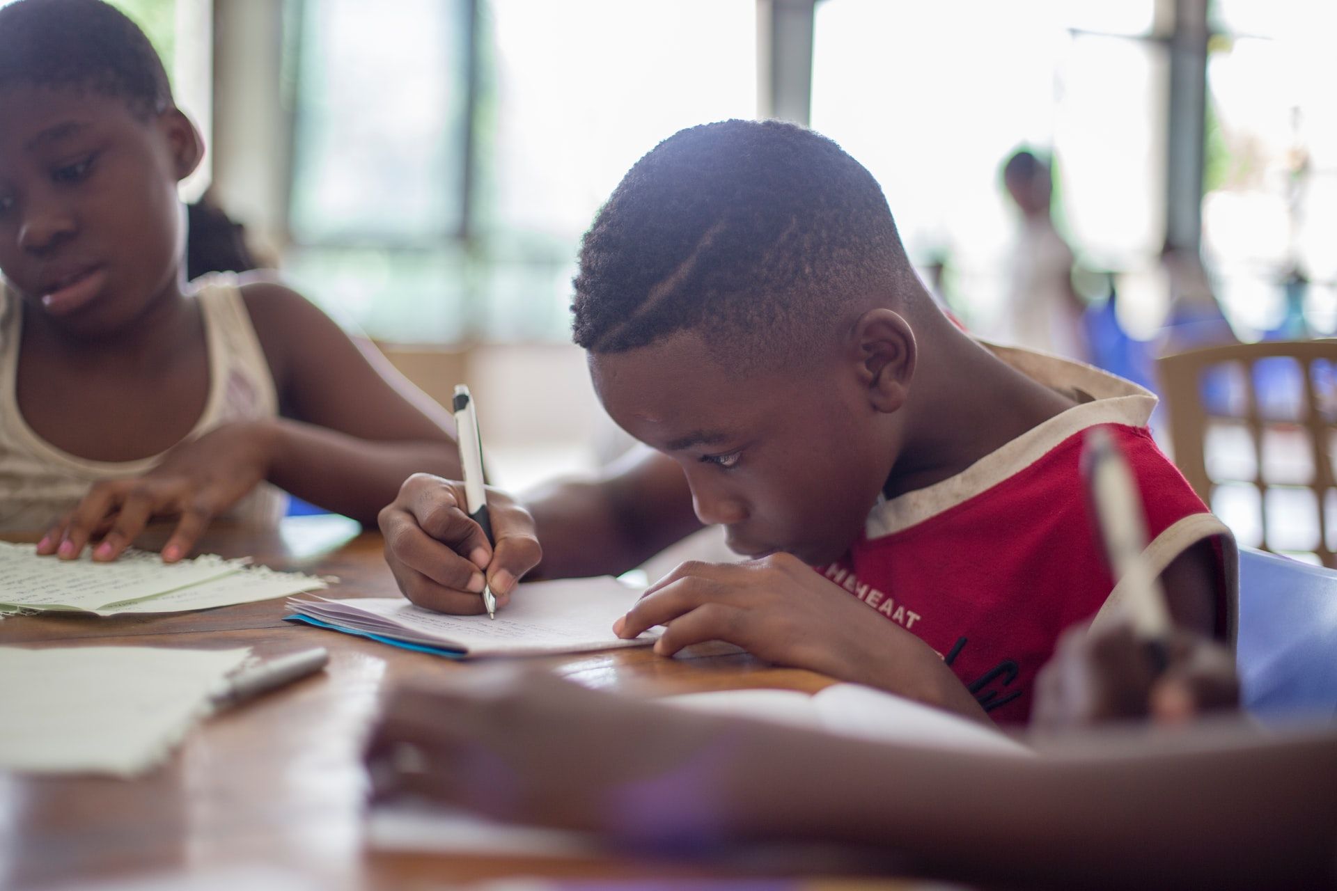 Boy and girl learning at table in school