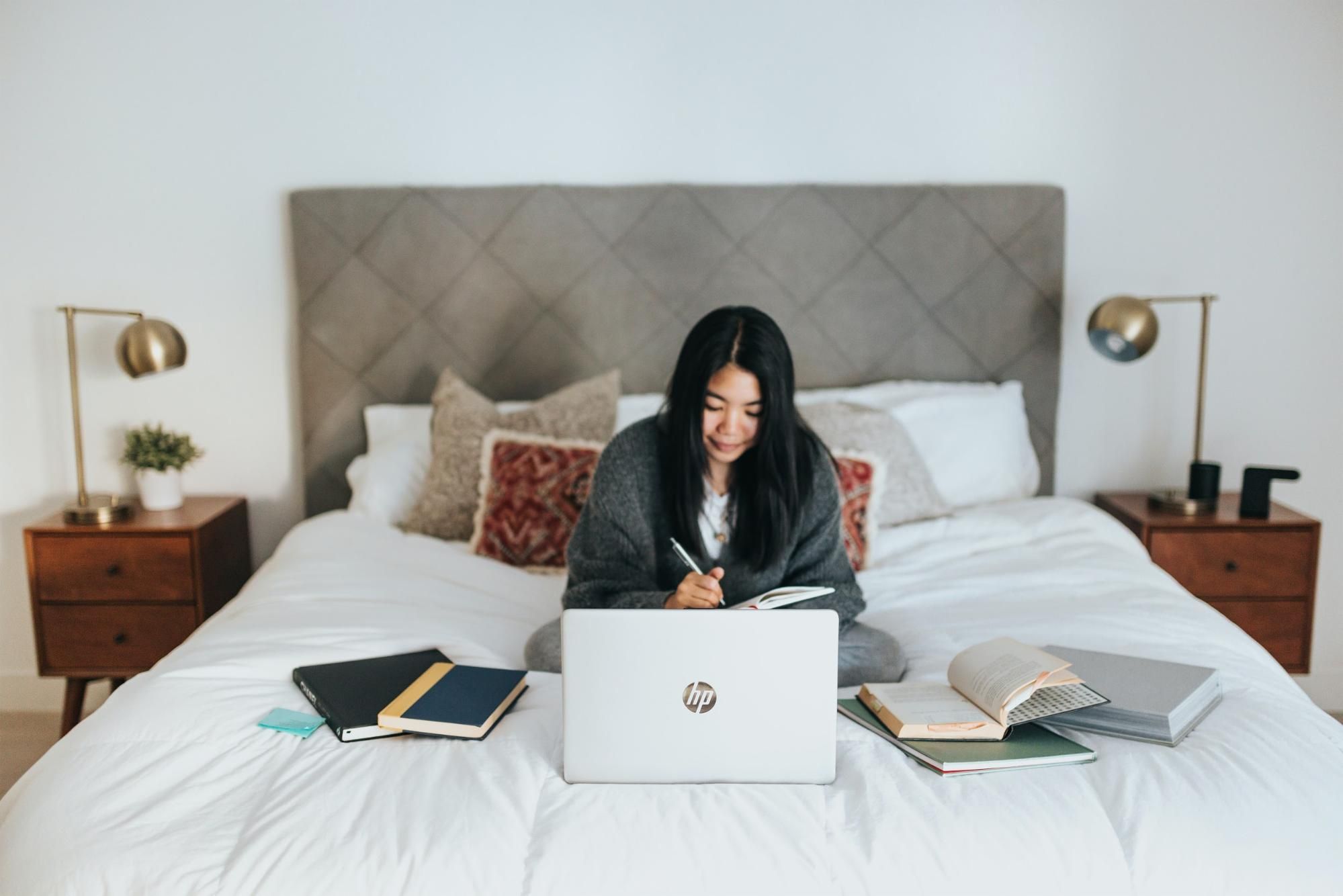 Girl studying in her bed for the WSET Level 3 exam