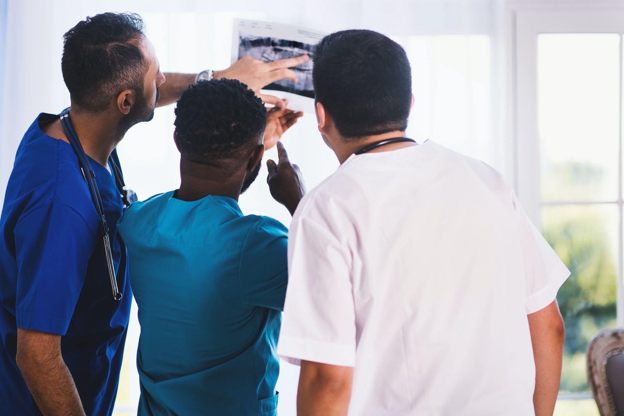 Nurses examining an x-ray; Nursing school