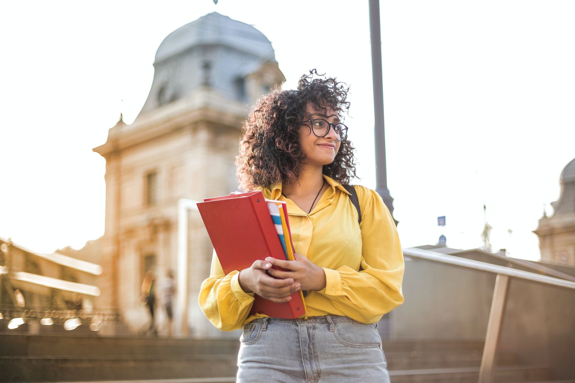 Student standing with notebooks; NCLEX-RN review course