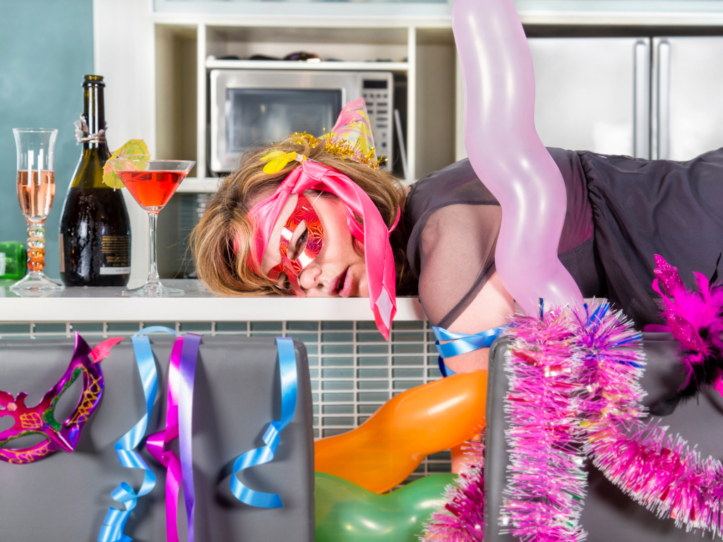 Girl being hangover with party decorations