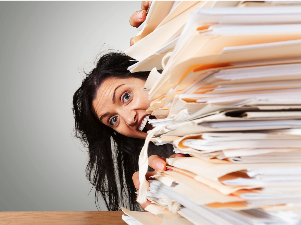 Girl hiding behind a stack of papers; Dropping a class