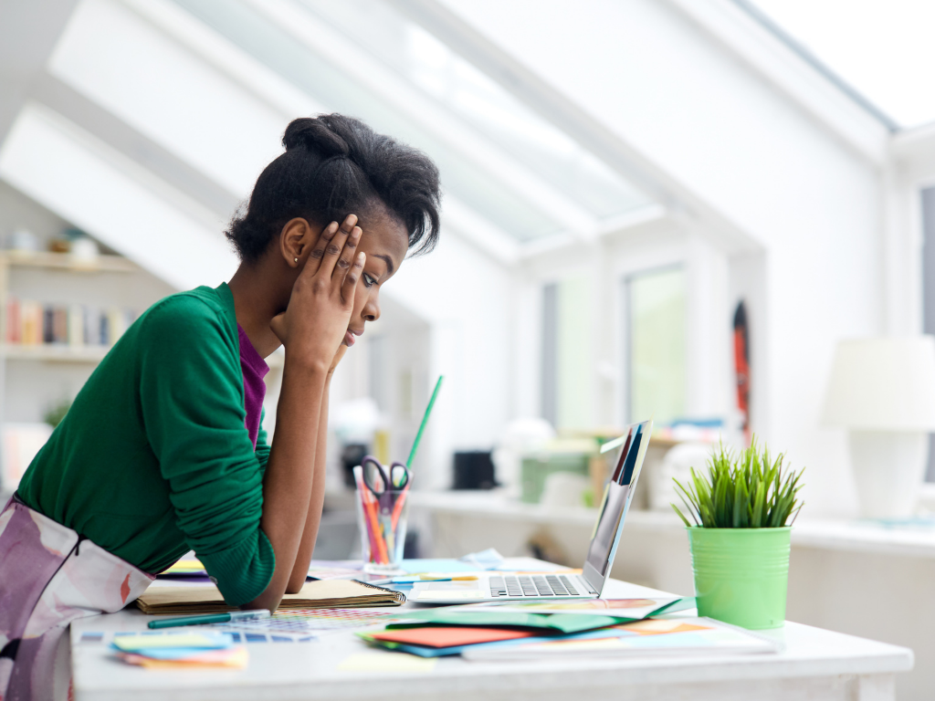 Girl leaning over desk; MCAT study