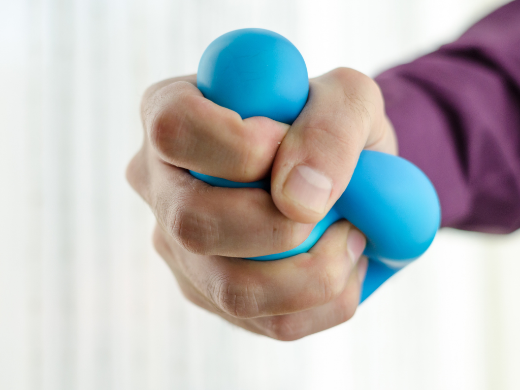 Squeezing a blue stress ball; bar exam stress