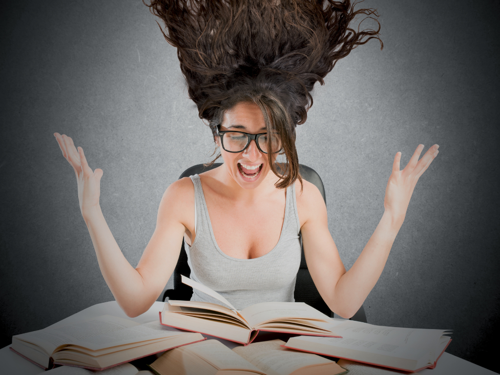 woman looking at books with hands in the air and mouth open; should I go to law school