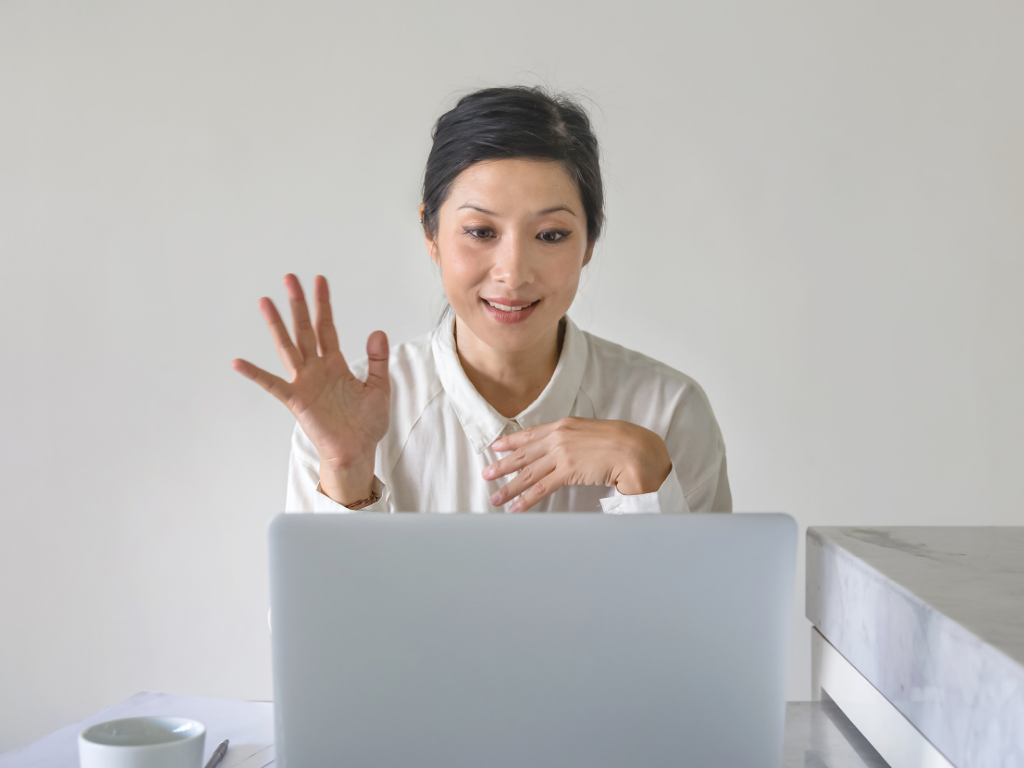 woman saying hello to computer for a online law firm interview