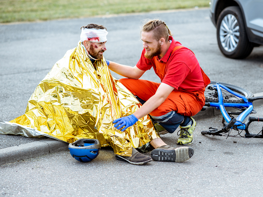 EMT comforting and treating a patient on the side of the road