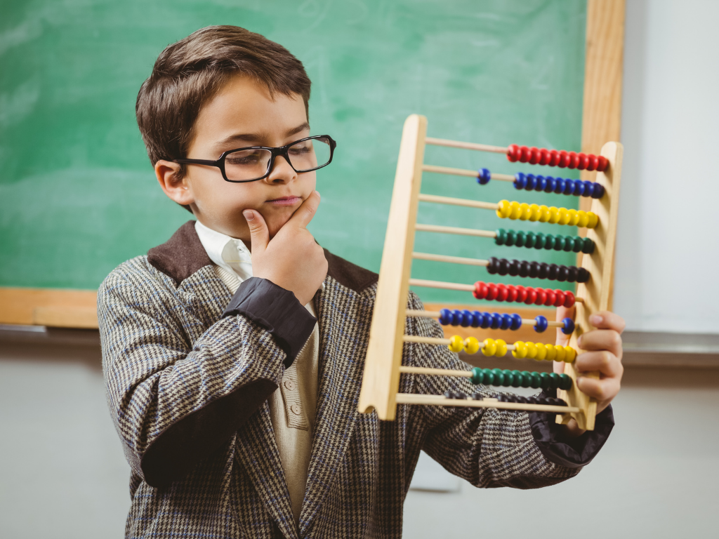 Kid with hand on chin thinking and looking at an abacus