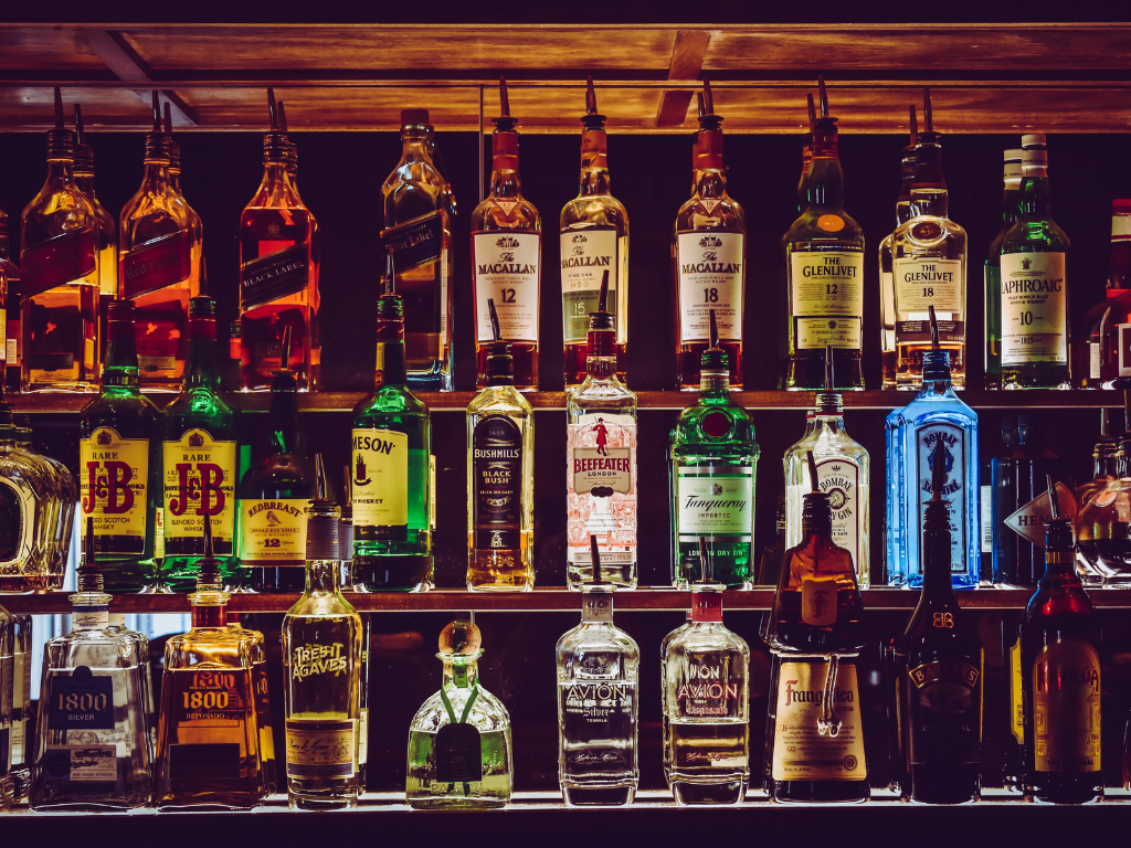 Shelf with 3 rows of liquor bottles