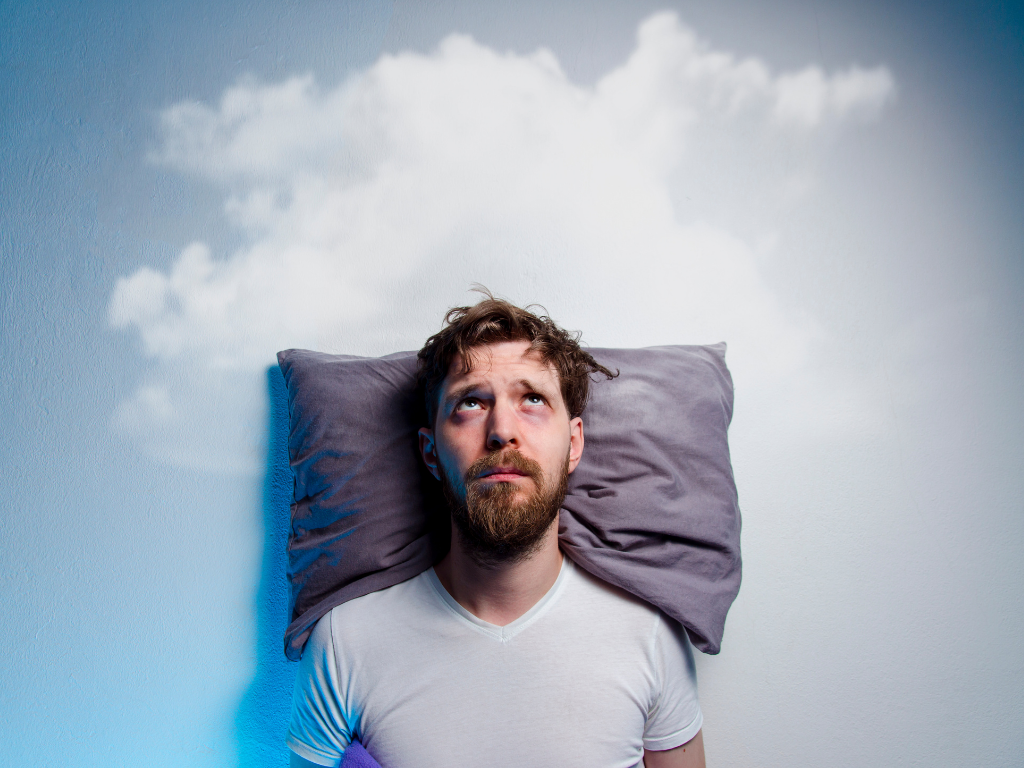 Man laying on pillow looking up at clouds