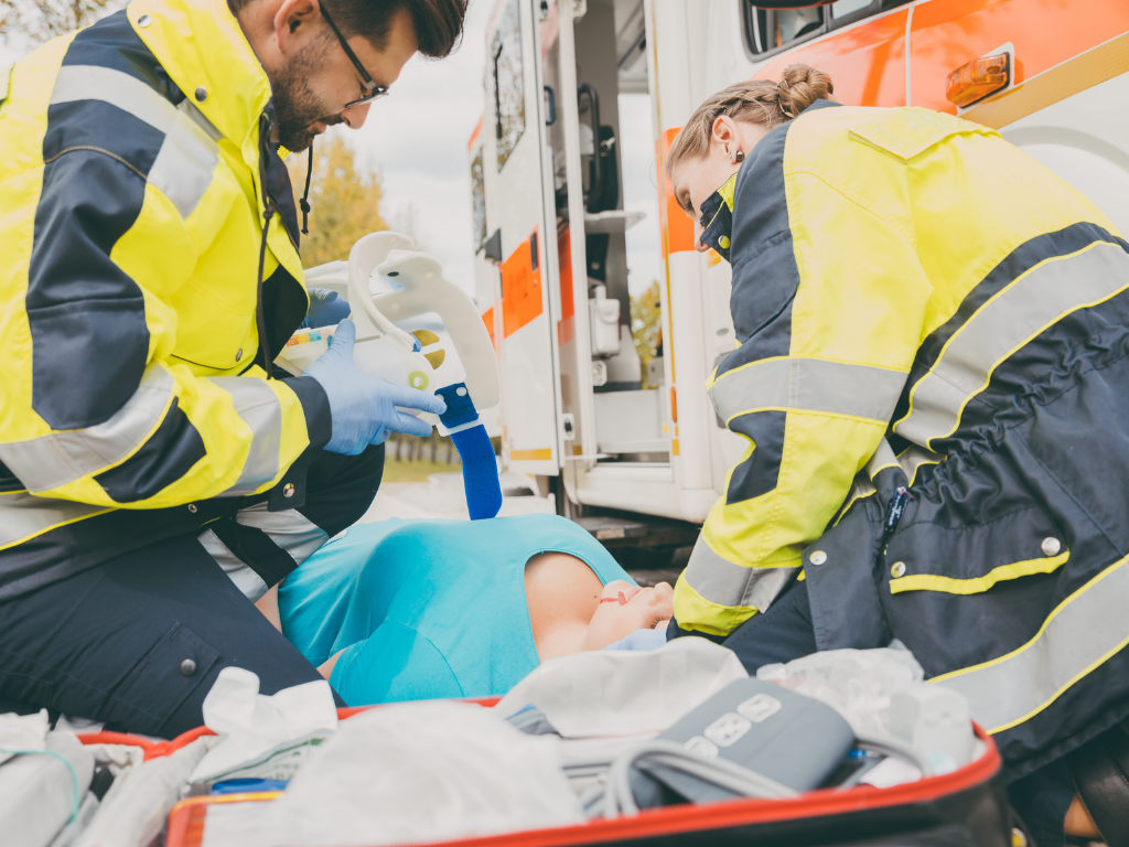 Two paramedics resuscitating a patient