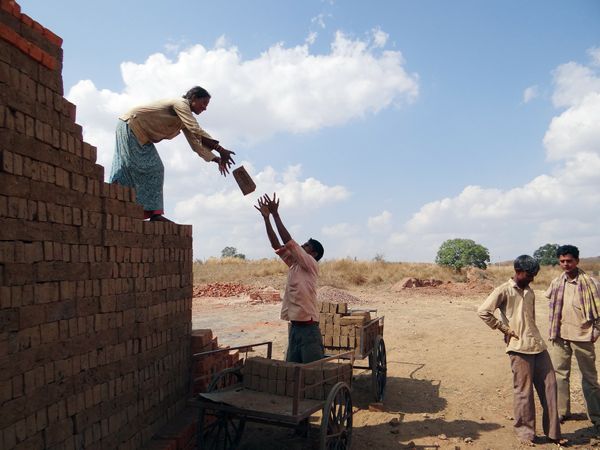 Workers building a wall